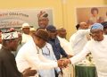 FCT Minister, Nyesom Wike (Right) in a handshake with the Rivers State APC Governorship candidate, Kingsley Chinda while the Governorship candidate of AA, Ben Eke (1st Left), others watch during a luncheon organised by the Rivers State Rainbow Coalition held in Port Harcourt on Saturday, in honour of candidates participating in the forthcoming Governorship, National Assembly and State Assembly elections in Rivers State